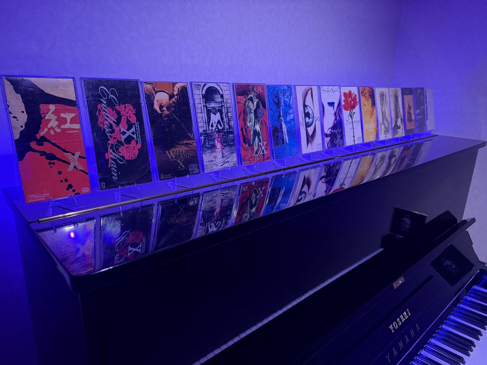 X JAPAN CD singles lit in blue — Kurenai, Endless Rain, WEEK END, Silent Jealousy and more
